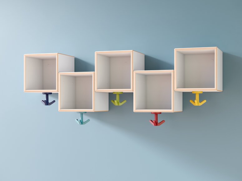 Wall-mounted boxes at different heights, to which colorful triple hooks are attached